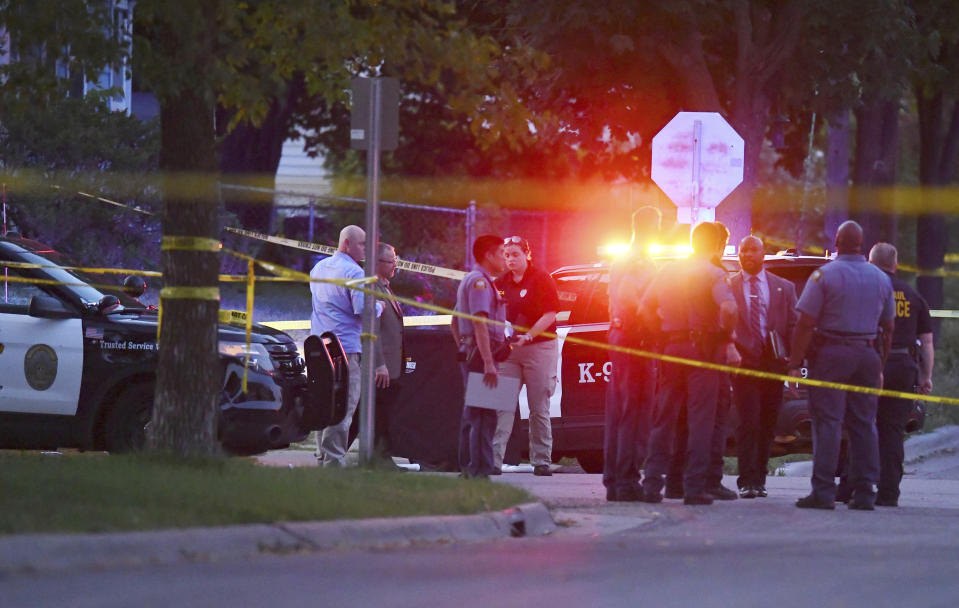 Investigators work the scene of an officer-involved shooting in the Midway area of St. Paul, Minn., on Sunday, Sept. 15, 2019. A St. Paul police officer fatally shot a man who rear-ended his squad car and fought with the officer, according to the police department. (John Autey/Pioneer Press via AP)