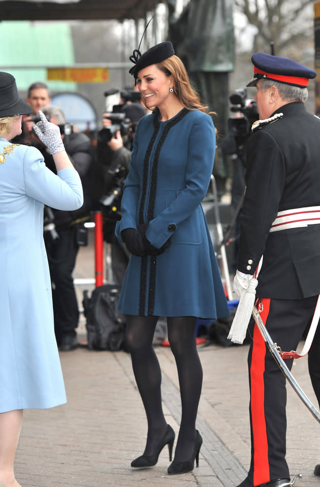 Kate Middleton wore a teal coat dress and black fascinator as she visited Baker Street station to celebrate London Underground's 150th birthday. Copyright [WENN]