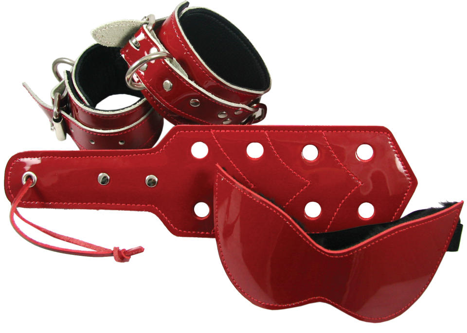 This product image released by Babeland shows a blindfold, a paddle and wrist and ankle restraints in red patent leather. Sales are roof-raising for Babeland since the surge in popularity from E L James' "Fifty Shades of Grey" book series. With three adult toy stores in New York, one in Seattle and a website, co-founder Claire Cavanah reports a 40 percent uptick in business overall, with eye-popping increases for bondage toys.(AP Photo/Babeland)