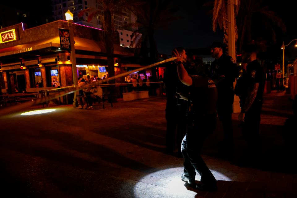 Law enforcement officers are seen on a crime scene as they respond to a shooting at Hollywood Beach on 29 May 2023 in Hollywood, Florida (Getty Images)