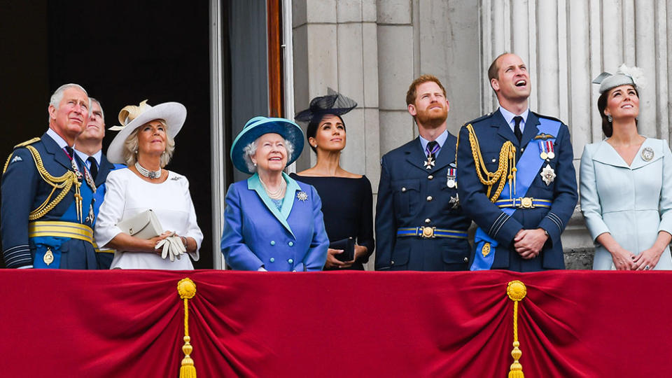 The Royal Family stand on a balcony