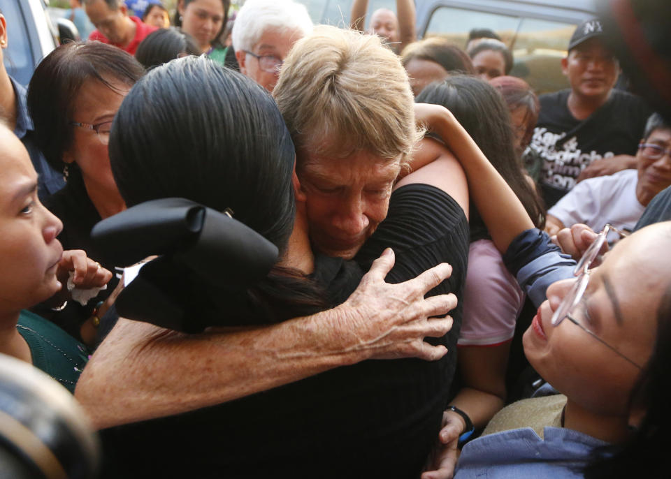 Australian Roman Catholic nun Sister Patricia Fox hugs to bid goodbye to supporters as she is escorted to the Ninoy Aquino International Airport for her flight to Australia Saturday, Nov. 3, 2018, in for the extension of her visa. Sr. Fox called on Filipinos to unite and fight human rights abuses ahead of her forced departure from the country. (AP Photo/Bullit Marquez)