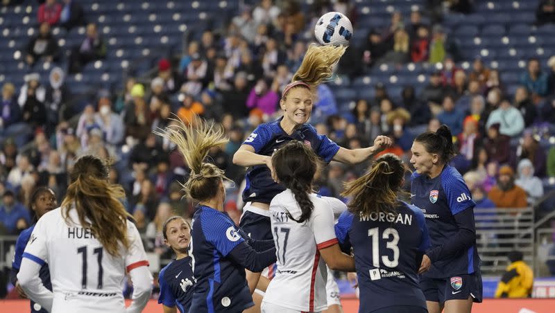 San Diego Wave midfielder Kristen McNabb, center, leaps for a header during the second half of the team's NWSL soccer match against the OL Reign, Thursday, April 14, 2022, in Seattle.  This week, the Wave signed the NWSL's youngest-ever player.
