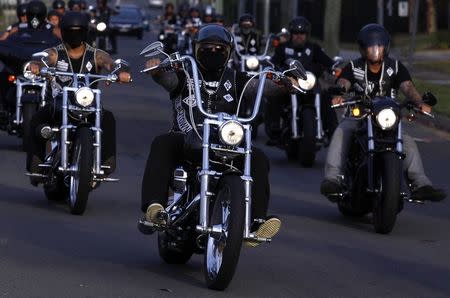 Mark "Ferret" Moroney (C), National President of the Mongols Motorcycle Club, leads fellow members in formation away from their clubhouse compound located in western Sydney November 9, 2014. REUTERS/David Gray