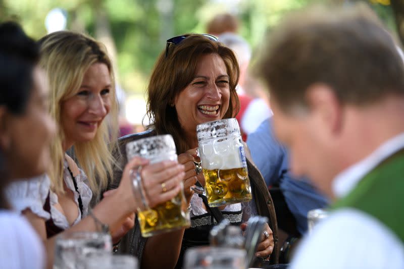 People attend the tapping of the first barrel at a beer garden near Theresienwiese in Munich