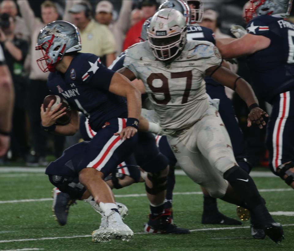 Kwabena Bonsu of Army sacks Tai Lavatai of Navy in the first half as Army faced Navy at MetLife Stadium in East Rutherford, NJ on December 11, 2021.