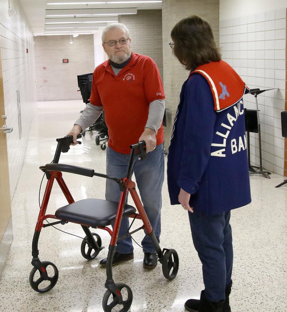 Former Alliance High School Marching Band members John Fontaine (class of 1970), left, and Jennifer Crist (class of 1973) chat just outside the band room at Alliance High School on Jan. 28. Ed Hall Jr. / Special To The Review