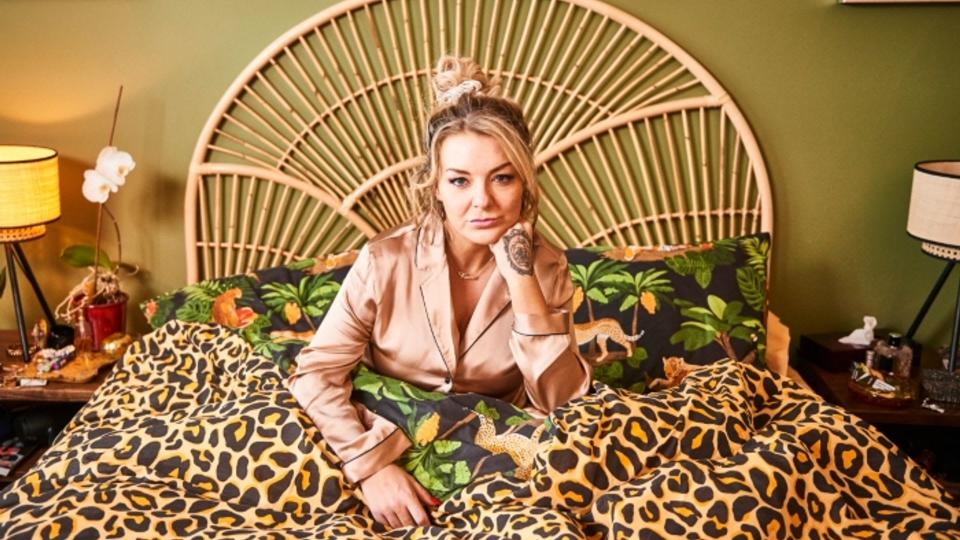 sheridan smith sits in bed as rosie molloy in sky comedy