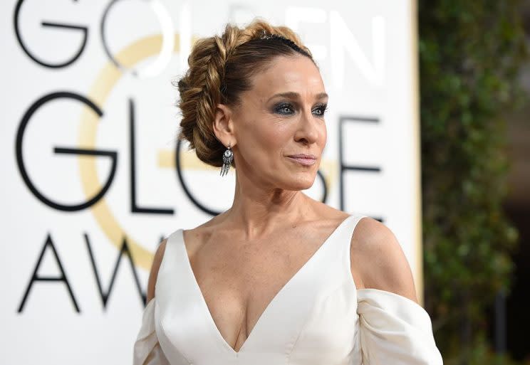 Actress Sarah Jessica Parker dominates with a braided bejeweled beehive bun at the 74th annual Golden Globe Awards. (Photo credit should read VALERIE MACON/AFP/Getty Images)