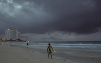 Clouds gather over Playa Gaviota Azul as Tropical Storm Zeta approaches Cancun, Mexico, early Monday morning, Oct. 26, 2020. A strengthening Tropical Storm Zeta is expected to become a hurricane Monday as it heads toward the eastern end of Mexico's resort-dotted Yucatan Peninsula and then likely move on for a possible landfall on the central U.S. Gulf Coast at midweek. (AP Photo/Victor Ruiz Garcia)