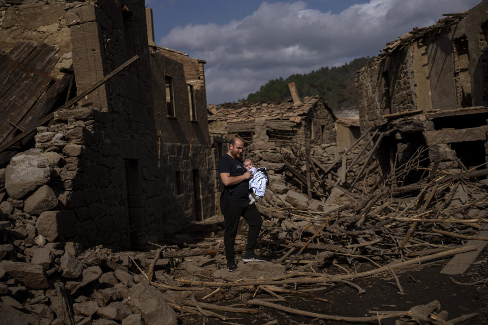 The roof of an old house, submerged three decades ago when a hydropower dam flooded the valley, is photographed emerged due to drought at the Lindoso reservoir, in northwestern Spain, Saturday, Feb. 12, 2022. Large sections of Spain are experiencing extreme or prolonged drought, with rainfall this winter at only one-third of the average in recent years. The situation is similar in neighboring Portugal, where 45% of the country is now enduring “severe” or “extreme” drought. (AP Photo/Emilio Morenatti)