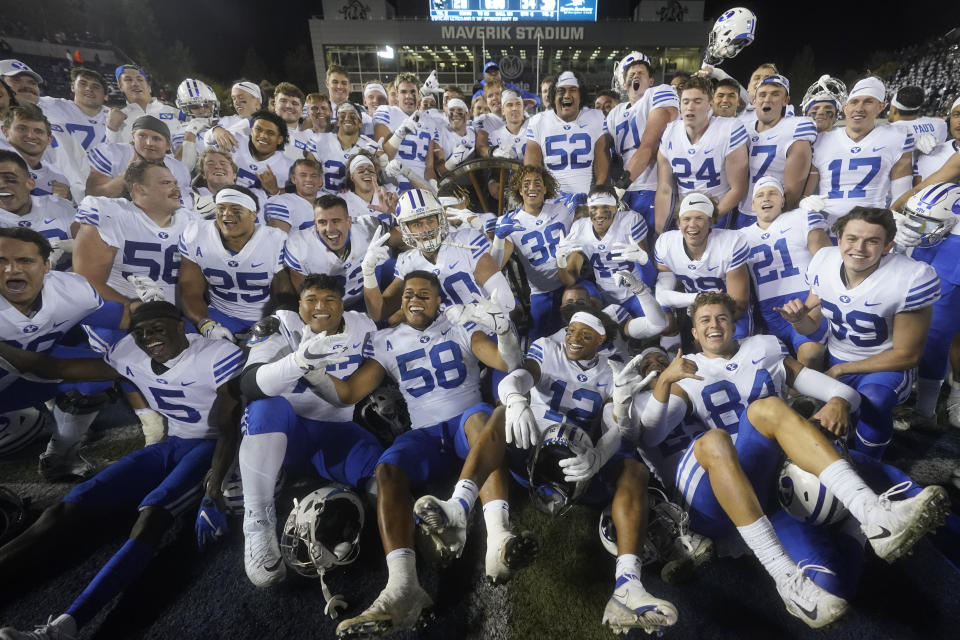 BYU players pose following their NCAA college football game against Utah State Friday, Oct. 1, 2021, in Logan, Utah. (AP Photo/Rick Bowmer)