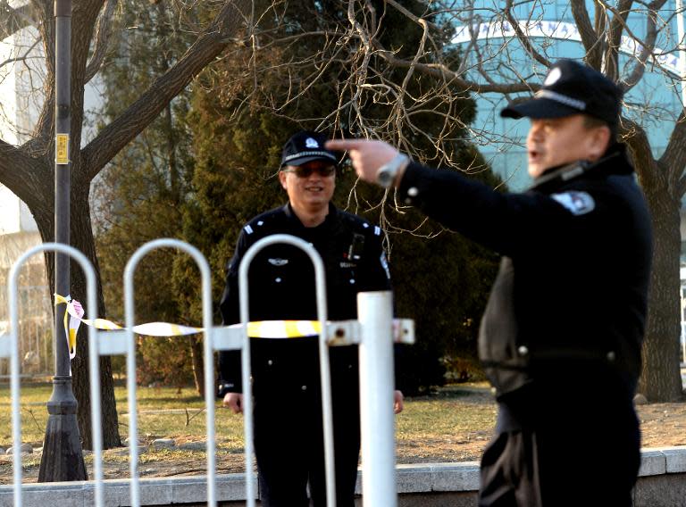 Police stand guard in Beijing outside the No. 1 Intermediate court, on January 22, 2014, as strict security was imposed ahead of the trial of Xu Zhiyong, one of China's most prominent dissidents