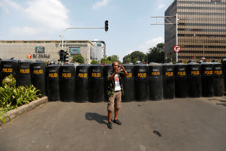 A man uses a phone during a protest following the announcement of the last month's presidential election results near the Election Supervisory Agency (Bawaslu) headquarters in Jakarta, Indonesia, May 22, 2019. REUTERS/Willy Kurniawan