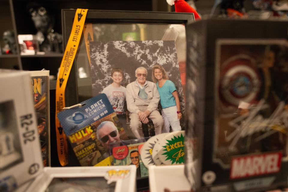 Staci Williams and her son Steiner are seen in a photograph with the legendary comic book writer Stan Lee from an early Comic-Con they attended.