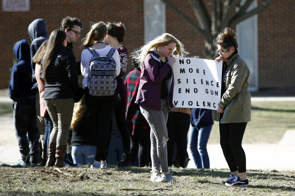 <p>Students hold a sign during a student walkout outside Perry Hall High School in Perry Hall, Md., Wednesday, March 14, 2018. Students across the country planned to participate in walkouts Wednesday to protest gun violence, one month after the deadly shooting inside a high school in Parkland, Florida. (Photo: Patrick Semansky/AP) </p>