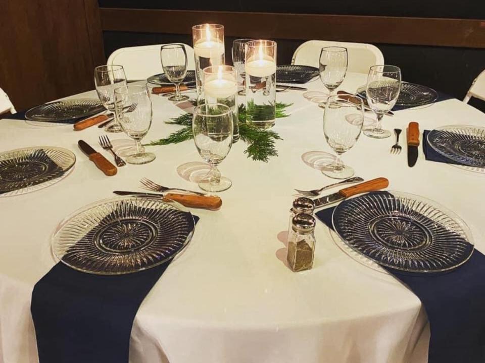 Table setting with blue napkins and crystal plates at wedding