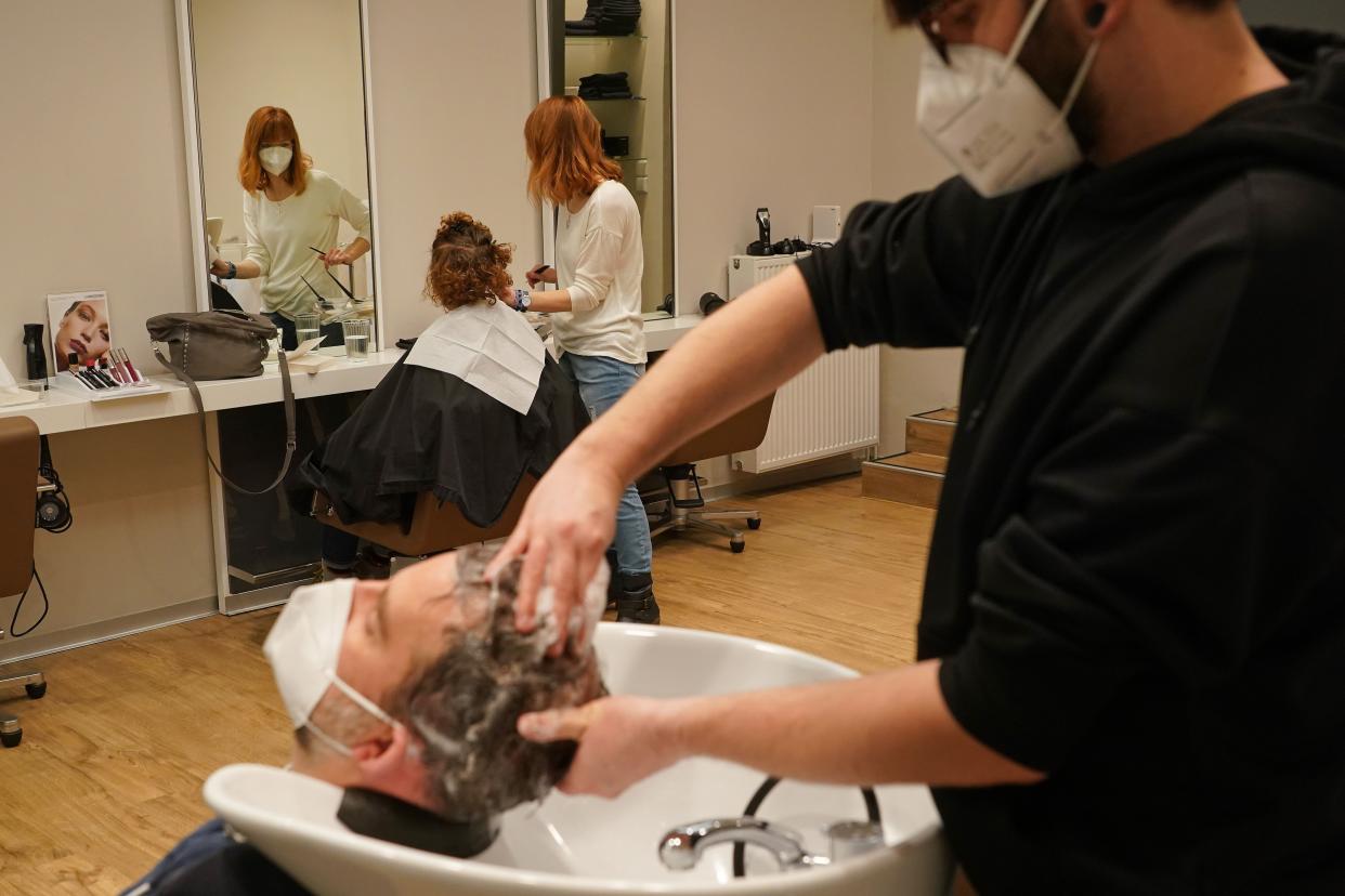 Hairstylists wash and cut hair at House of Hair salon on the first day it reopened since a hard lockdown went into effect last December during the coronavirus pandemic on March 1, 2021, in Berlin, Germany. States across Germany are easing some lockdown measures, with hair salons reopening nationwide and home improvement stores, gardening centers and flower shops also reopening in some states.