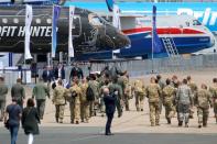 A man takes a picture of aircrafts on static display, at the eve of the opening of the 53rd International Paris Air Show at Le Bourget Airport near Paris