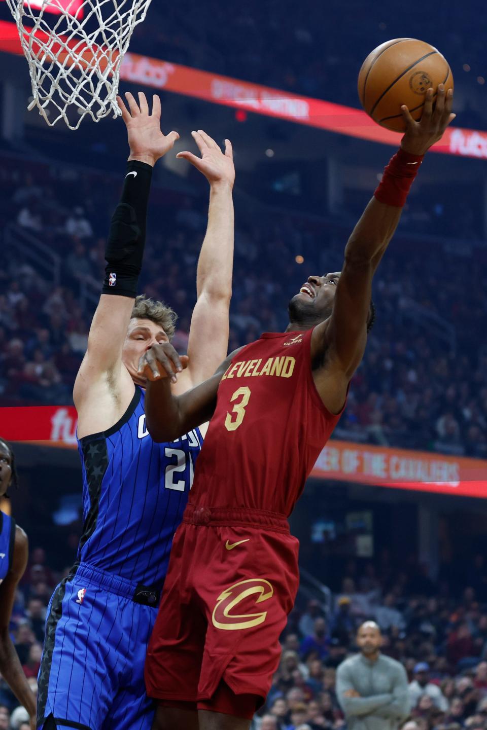 Cleveland Cavaliers guard Caris LeVert (3) shoots against Orlando Magic center Moritz Wagner (21) during the first half of an NBA basketball game Friday, Dec. 2, 2022, in Cleveland. (AP Photo/Ron Schwane)