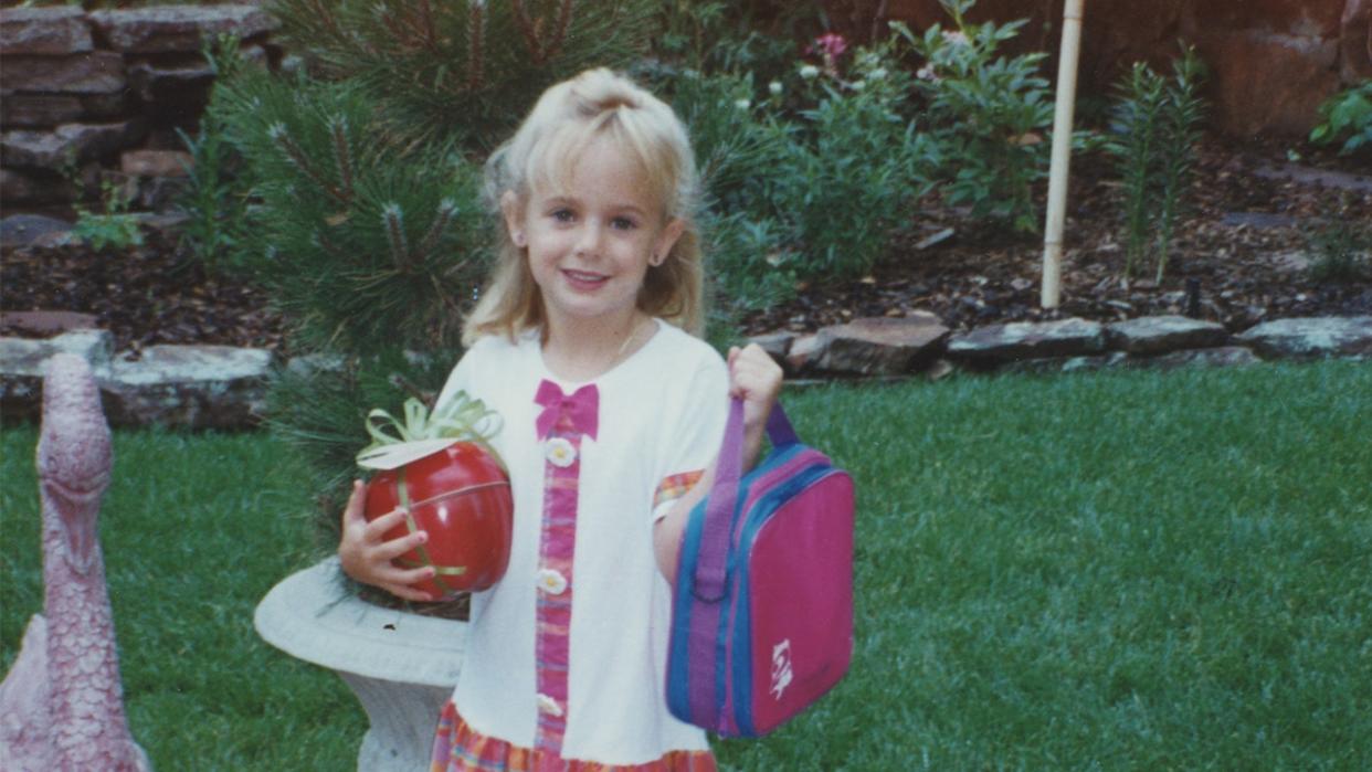 JonBenet Ramsey holding a backpack