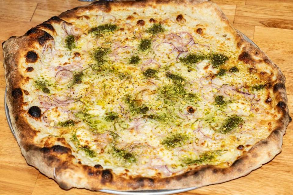 The Rosemary pizza at Pizza Baby has pistachio pesto, shaved red onions, pecorino and hot honey.