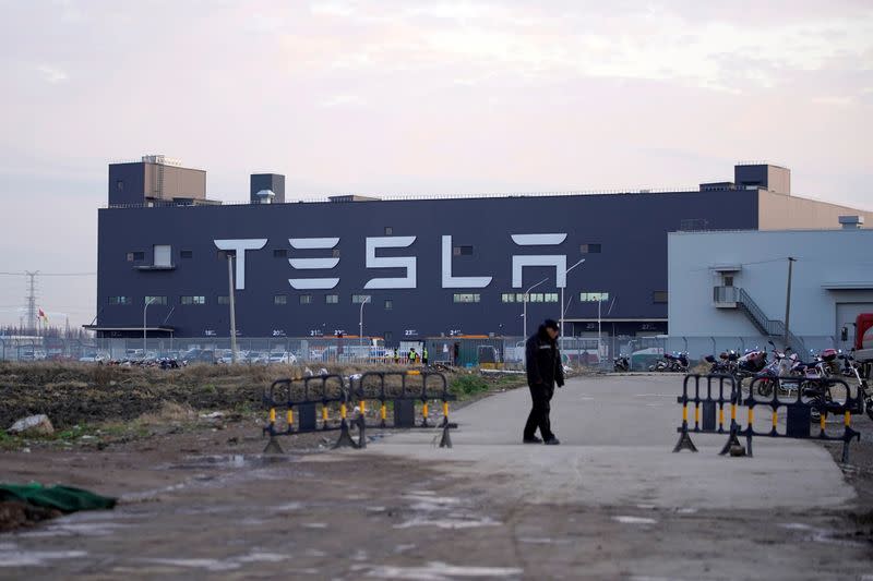 FILE PHOTO: A Tesla sign is seen on the Shanghai Gigafactory of the U.S. electric car maker before a delivery ceremony in Shanghai