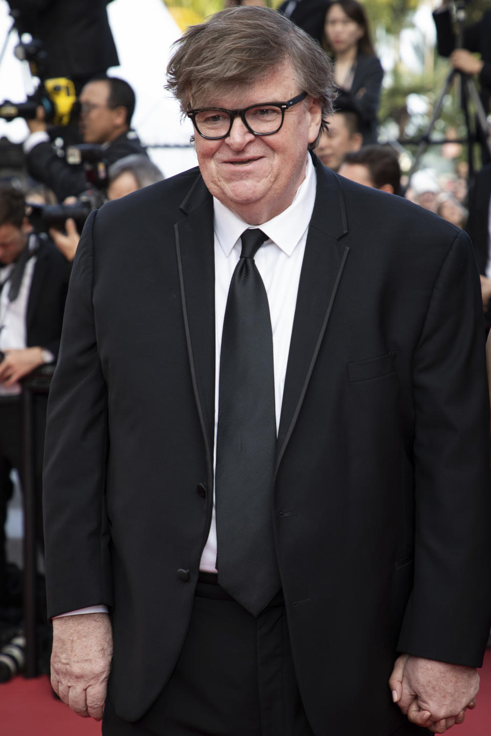 FILE - This May 25, 2019 file photo shows Michael Moore at the awards ceremony of the 72nd international film festival, Cannes, southern France. In "Planet of the Humans," which premiered Wednesday, July 31, at the Traverse City Film Festival, he and director Jeff Gibbs pull the curtain back on the false promises of alternative energy, from electric cars to windmills and biomass, and expose why they're not working. (Photo by Vianney Le Caer/Invision/AP, File)