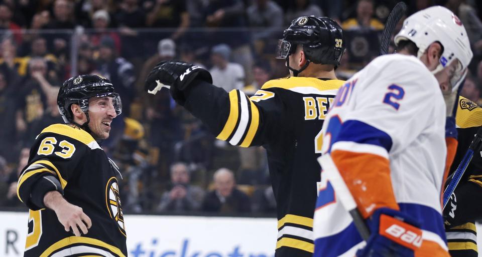 <p>
              Boston Bruins center Patrice Bergeron, center, is congratulated by teammate Brad Marchand, left, after his goal during second period of an NHL hockey game in Boston, Tuesday, Feb. 5, 2019. At right skating past is New York Islanders defenseman Nick Leddy (2). (AP Photo/Charles Krupa)
            </p>