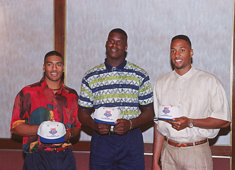Louisiana State University player Shaquille O'Neal, center, Alonzo Mourning, right, of Georgetown, and Jim Jackson of Ohio State pose together as they hold NBA draft hats in Portland, Ore., on June 23, 1992. (AP Photo/Jack Smith)