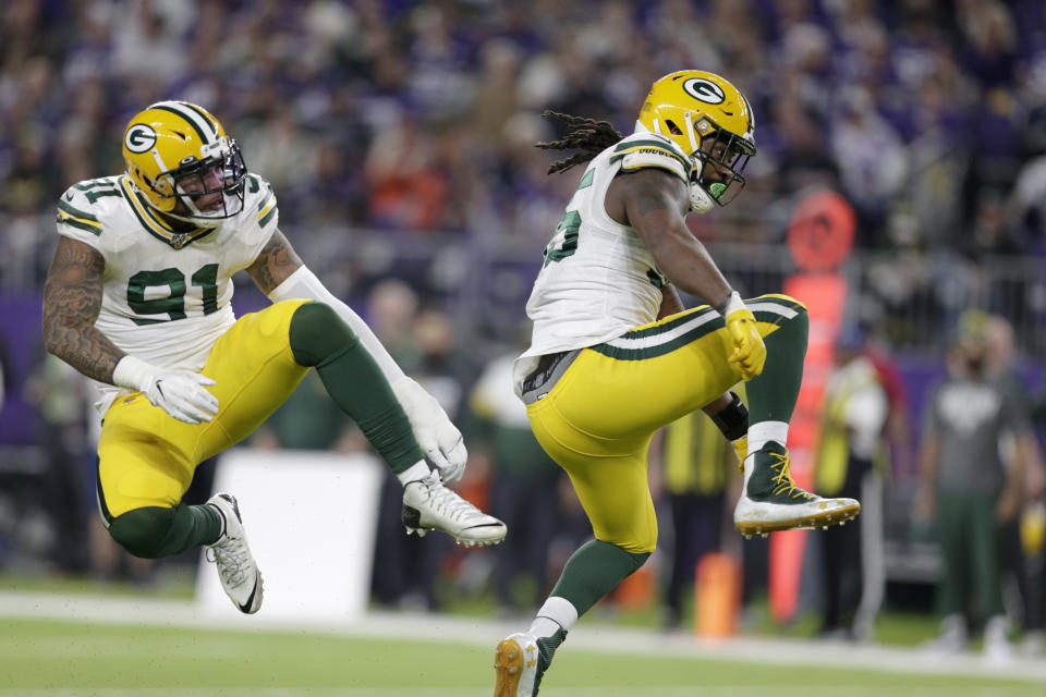 FILE - In this Monday, Dec. 23, 2019, file photo, Green Bay Packers outside linebacker Za'Darius Smith, right, celebrates with teammate Preston Smith after sacking Minnesota Vikings quarterback Kirk Cousins during the second half of an NFL football game in Minneapolis. Za’Darius Smith and Preston Smith aren’t related, but the Packers pass rushers share the same last name and the same type of productive games. They combined for 25 ½ sacks last season after both signed with the Packers as free agents in early 2019. (AP Photo/Andy Clayton-King, File)