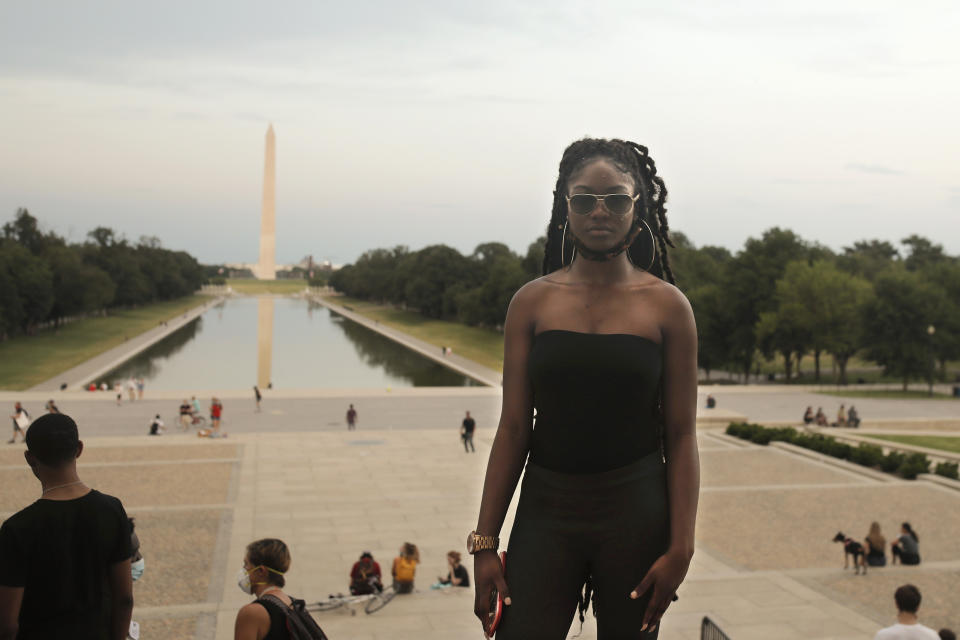 Aalayah Eastmond, a Parkland, Fla. activist, poses for a portrait with the Washington Monument on Wednesday, June 10, 2020, after leading the crowd in chants at the Lincoln Memorial in Washington, during protests over the death of George Floyd, a Black man who died after being restrained by Minneapolis police officers on May 25. (AP Photo/Maya Alleruzzo)