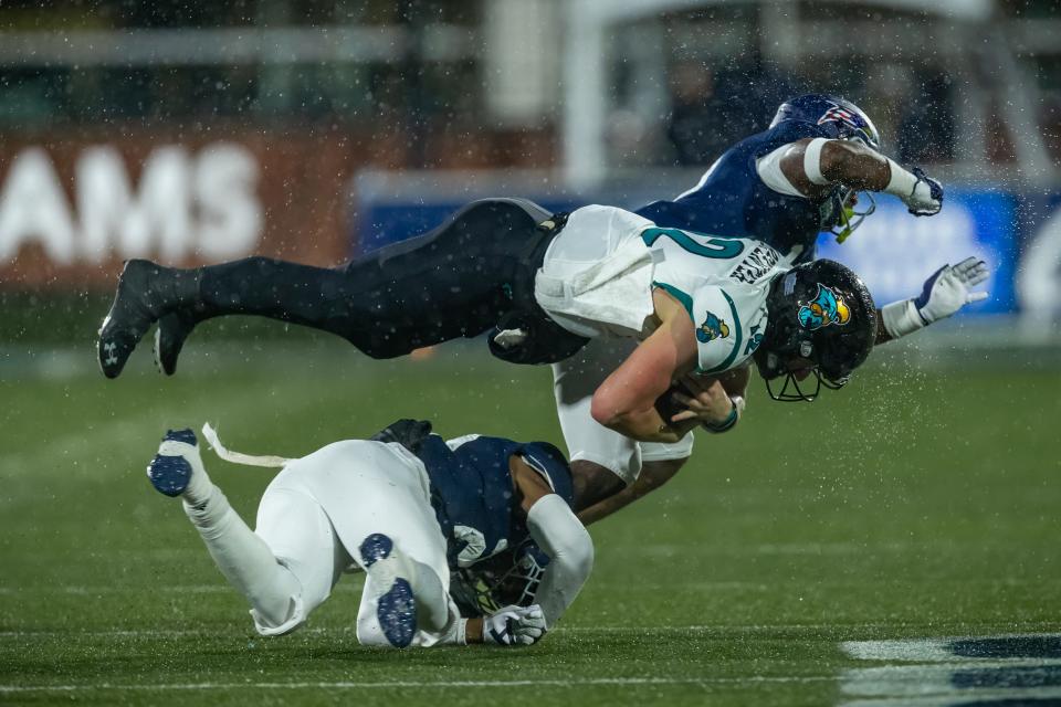 Coastal Carolina senior quarterback Bryce Carpenter (12) takes on two Georgia Southern defenders during the game Nov. 6, 2021 at Paulson Stadium in Statesboro. The teams play Oct. 1, 2022 in Conway, S.C.