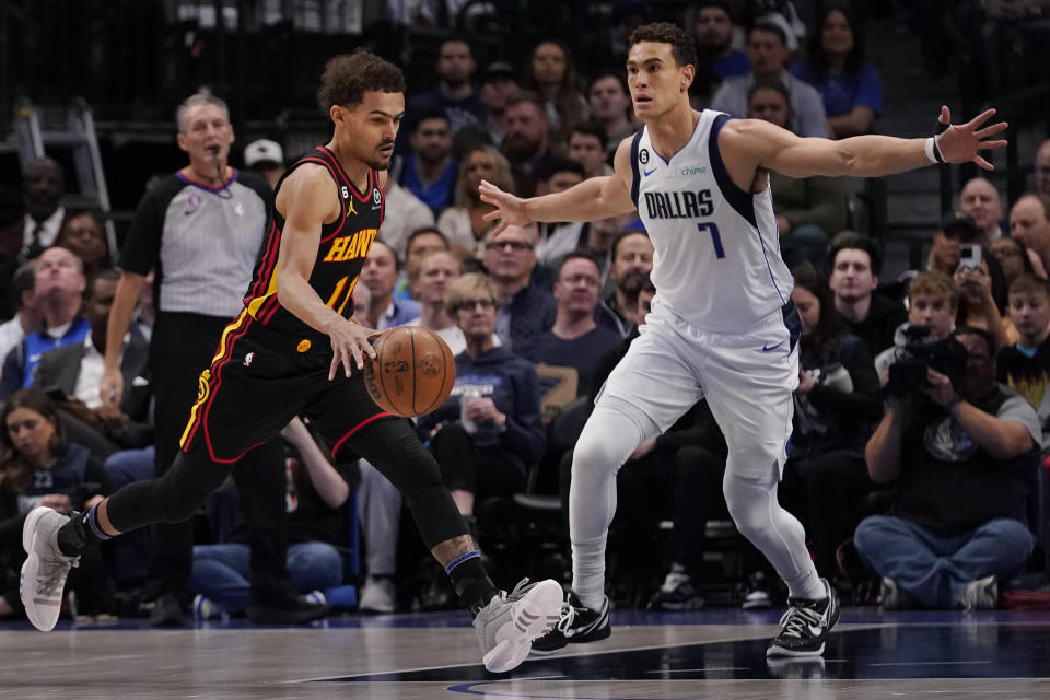 Atlanta Hawks guard Trae Young (11) drives against Dallas Mavericks center Dwight Powell (7) during the first quarter of an NBA basketball game in Dallas, Wednesday, Jan. 18, 2023. (AP Photo/LM Otero)