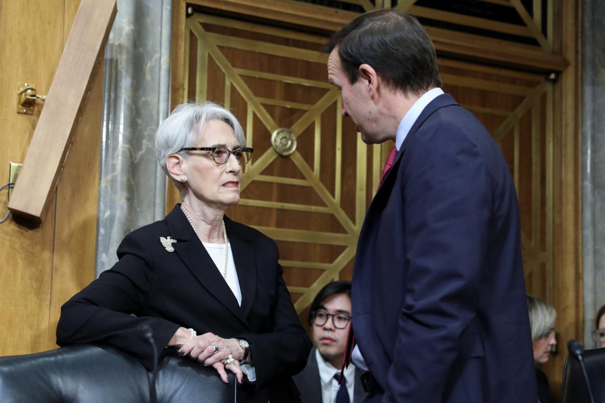 Senator Chris Murpy, right, speaks to Deputy Secretary of State Wendy Sherman before a Senate Foreign Relations Committee hearing on 9 February. (REUTERS)