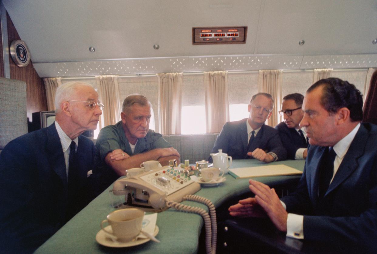 President Nixon in a meeting on Air Force One.