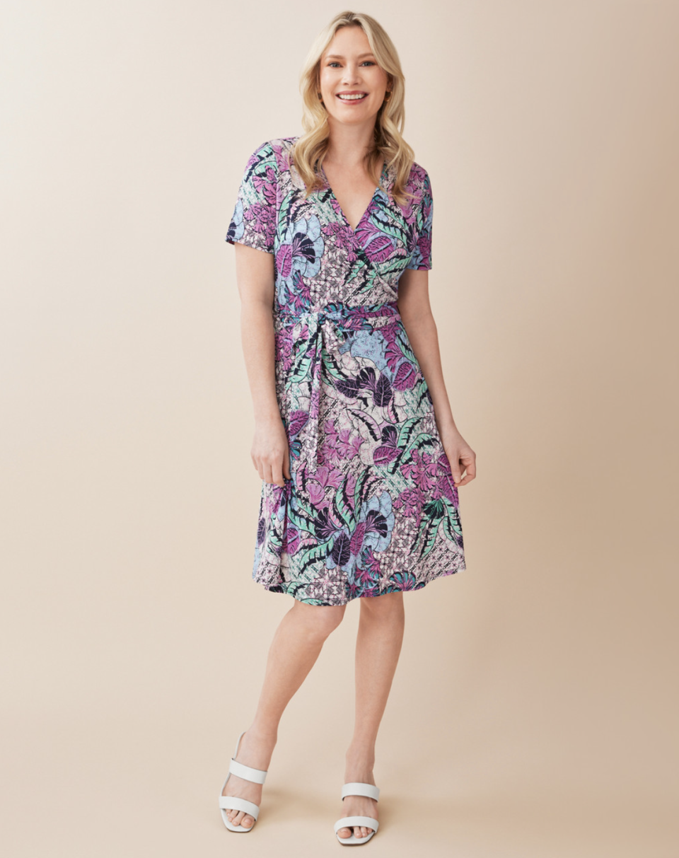 blonde model wearing white sandals and floral Abstract Floral Wrap Dress (photo via Northern Reflections)