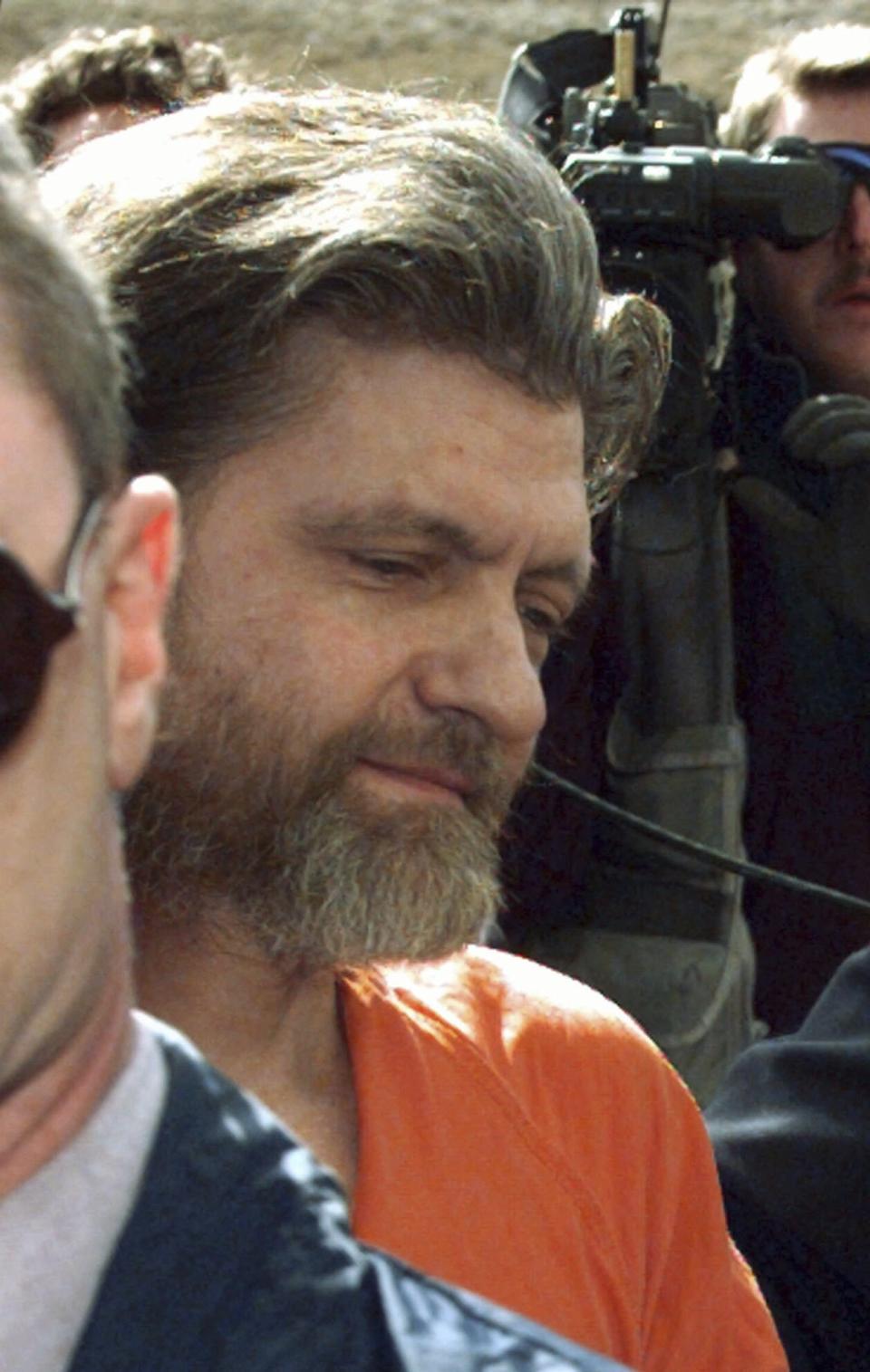 FILE - Theordore John Kaczynski, the suspected Unabomber, is led into the federal courthouse in Helena, Mont., Thursday, April 4, 1996, to face a charge of possession of bomb components. Kaczynski, known as the “Unabomber,” has died in federal prison, a spokesperson for the Bureau of Prisons told The Associated Press on Saturday, June 10, 2023. (AP Photo/Elaine Thompson, File)