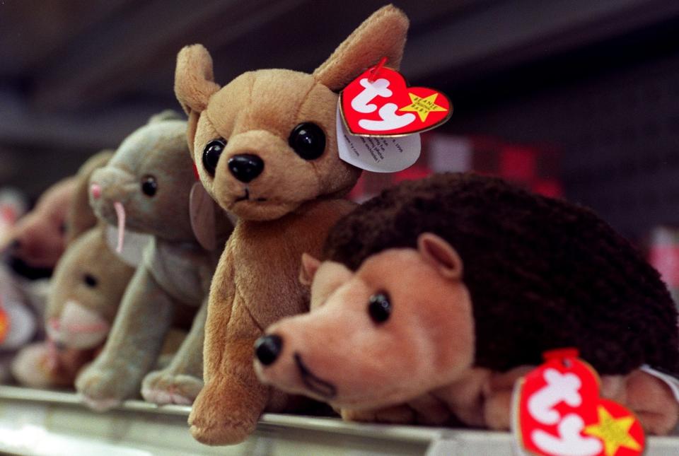 a group of beanie babies on a shelf