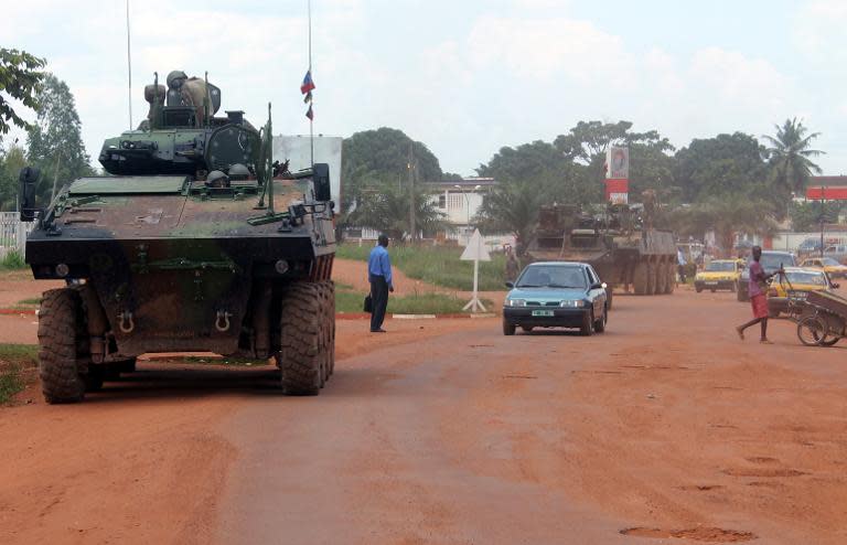 French Sangaris troops patrol aboard a military vehicule on August 16, 2014 in a street of Bangui, the Central African capital