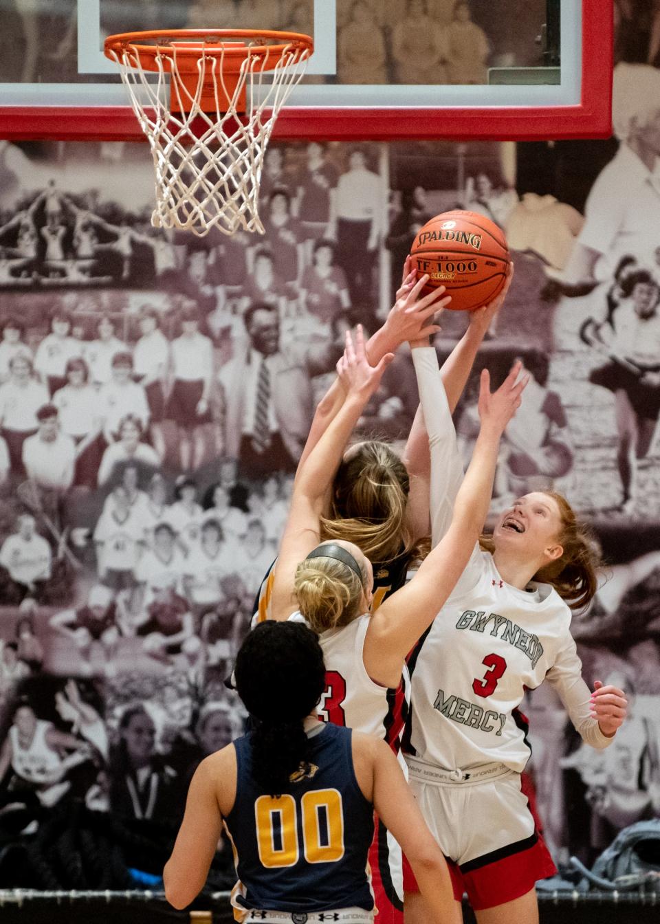 Gwynedd Mercy's Jenna Mangan, left, and Cara Lapp, right, battle New Hope-Solebury's Reagan Chrencik for a rebound in a District One Class 4A semifinal game, on Tuesday, February 22, 2022, at Gwynedd Mercy Academy High School in Lower Gwynedd. The Monarchs advance to the Class 4A final after defeating the Lions 56-28.