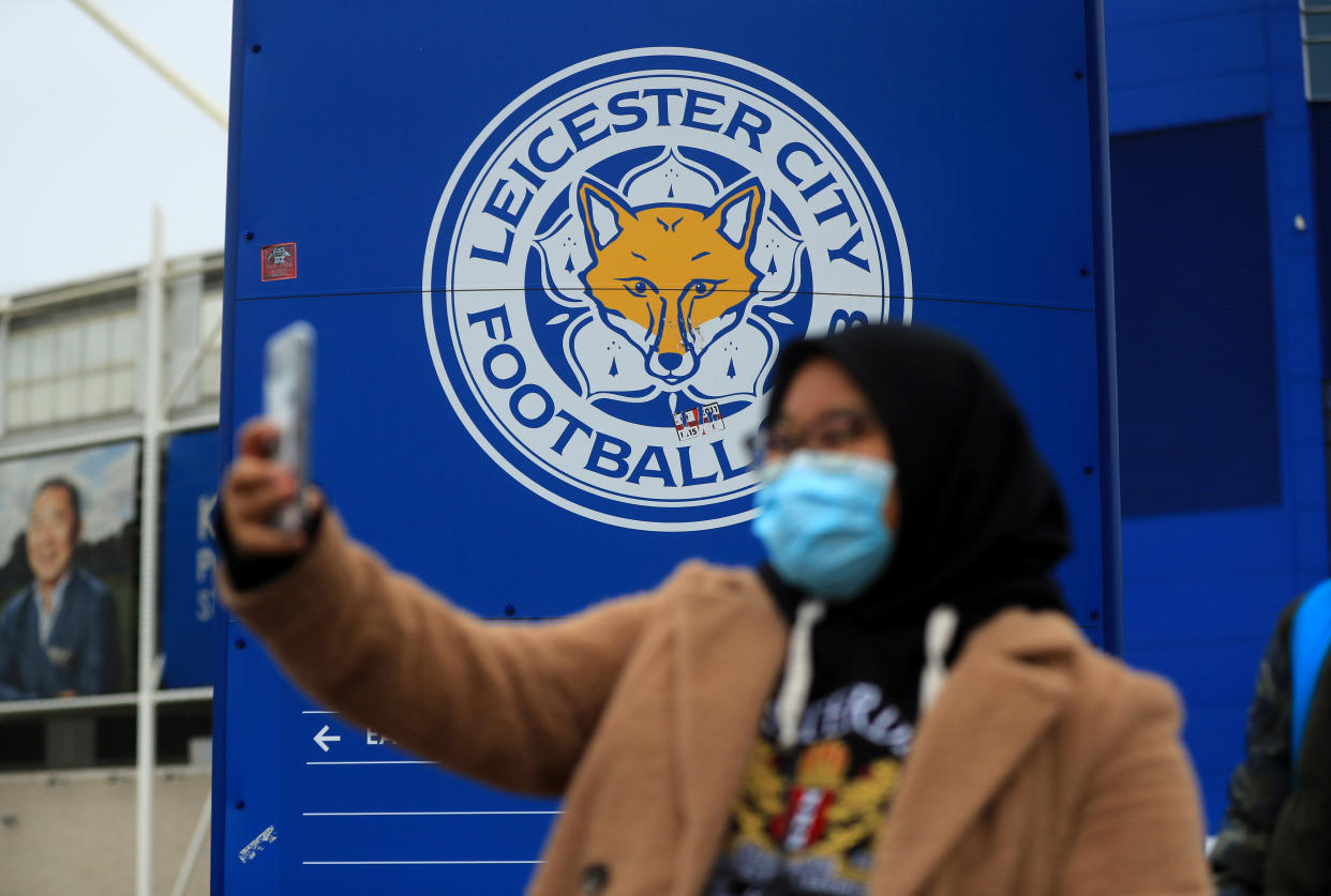 A fan takes a selfie in front of the Leicester City logo outside King Power Stadium, home of Leicester City. Premier League clubs will gather via conference call on Thursday morning to discuss fixtures and finances amid the coronavirus pandemic. Top-flight action is suspended until April 4 at the earliest, and measures around social distancing mean no clubs will be present in person for the meeting. (Photo by Mike Egerton/PA Images via Getty Images)