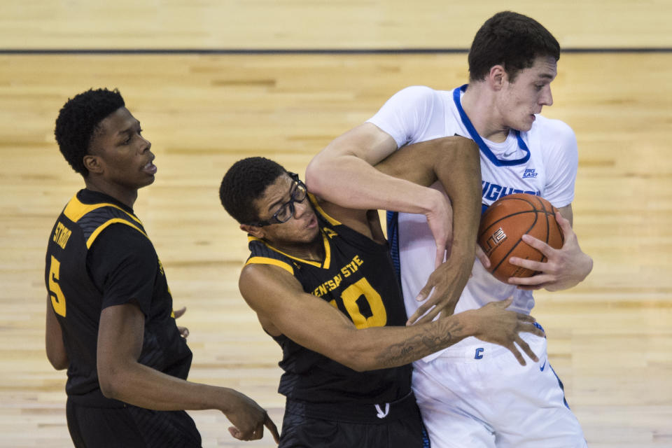 Creighton's Ryan Kalkbrenner pulls in a rebound next to Kennesaw State's Alex Peterson, center, and Brandon Stroud during the first half of an NCAA college basketball game in Omaha, Neb., Friday, Dec. 4, 2020. (AP Photo/Kayla Wolf)