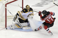 Boston Bruins goaltender Tuukka Rask (40) deflects a shot by New Jersey Devils' Yegor Sharangovich during the first period of an NHL hockey game Thursday, Jan. 14, 2021, in Newark, N.J. (AP Photo/Bill Kostroun)