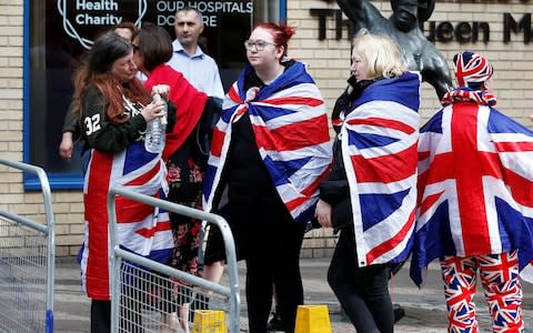 Supporters of the royal family stand outside the Lindo Wing of St Mary's Hospital - Credit: HENRY NICHOLLS /Reuters