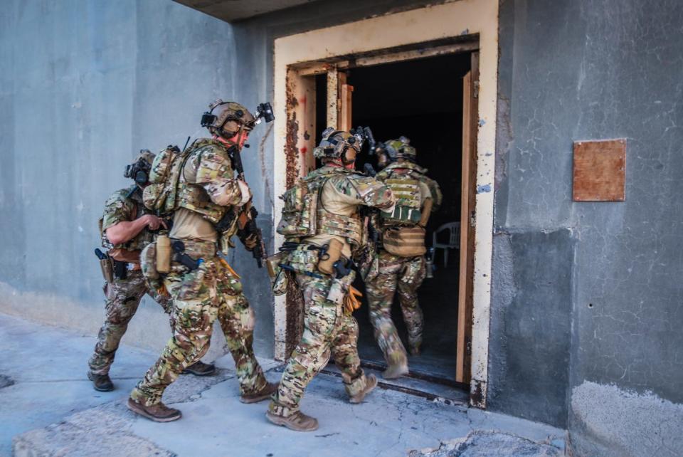Green Berets with the 5th Special Forces Group (Airborne), maneuver through a building while conducting room clearing and close quarters battle training.