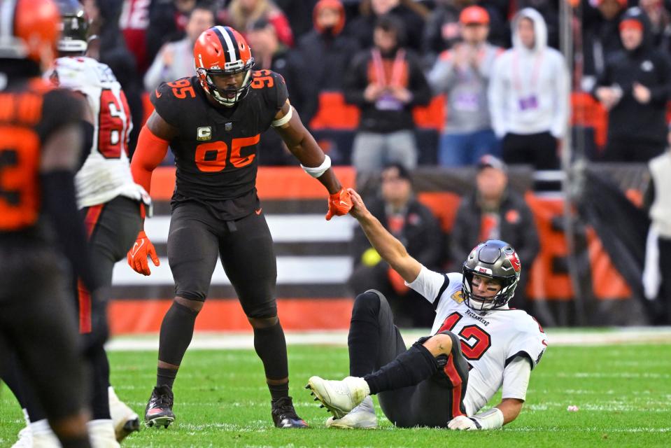 Browns defensive end Myles Garrett helps up Buccaneers quarterback Tom Brady after sacking him during the second half in Cleveland, Sunday, Nov. 27, 2022. The Browns won 23-17.