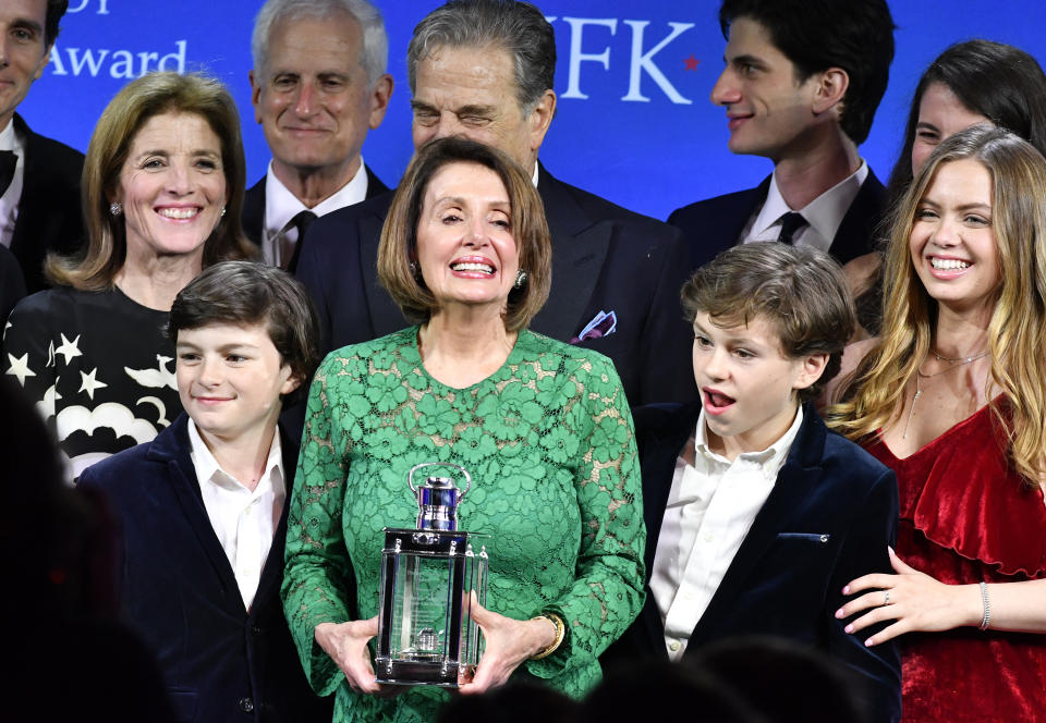 Speaker of the House Nancy Pelosi, D-Calif., center, stands with family, including her grandchildren Thomas Vos, left, and Paul Vos, right, as she receives the 2019 John F. Kennedy Profile in Courage Award, Sunday, May 19, 2019, at the John F. Kennedy Presidential Library and Museum in Boston. (AP Photo/Josh Reynolds)