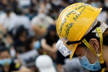 An anti-extradition bill protester wears a helmet during a protest at the arrival hall of Hong Kong Airport