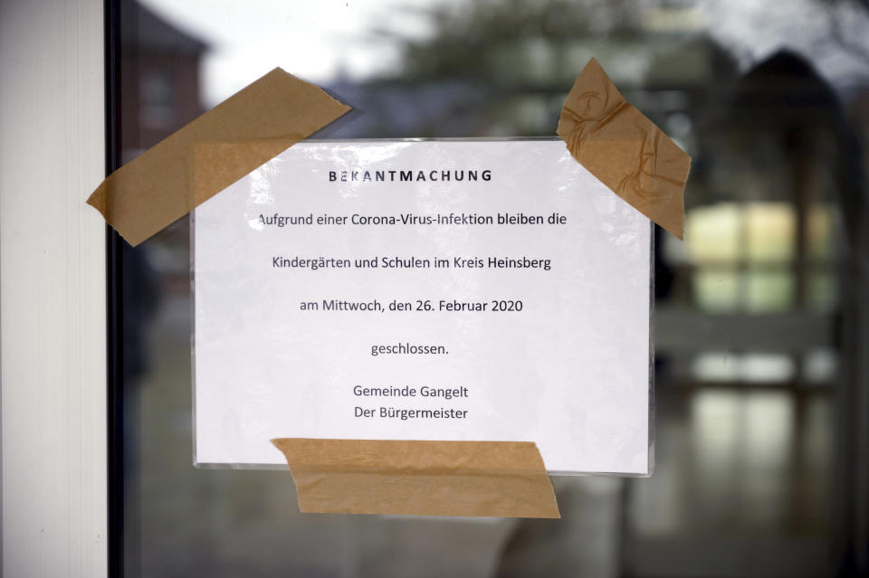 An announcement indicates that the school was closed due to the coronavirus is displayed at the Gangelt-Selfkant comprehensive school in Gangelt, western Germany, Wednesday, Feb. 25, 2020. The first confirmed coronavirus case in Germen state North Rhine-Westphalia comes from Gangelt. The announcement reads: In due of avirus invention the kindergartens and schools in the district Heinsberg stay closed on Wednesday, Feb. 26, 2020, municipality Gangelt the mayor. (Henning Kaiser/dpa via AP)